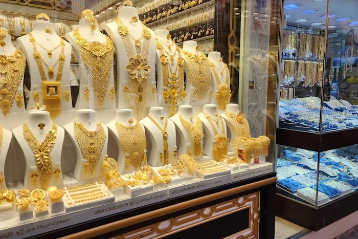 Gold necklaces on display in a shop window at the Dubai gold souk
