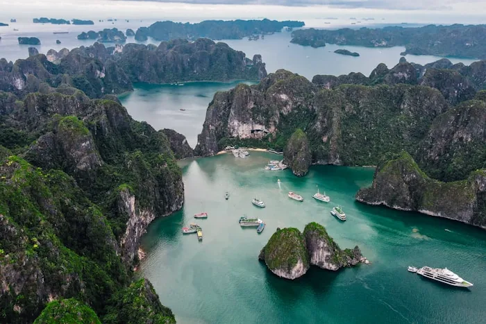 Aerial view of limestone islands and boats in Halong Bay