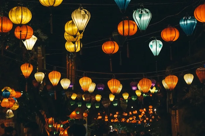 Coloured silk lanterns lit up over a street in Hoi An