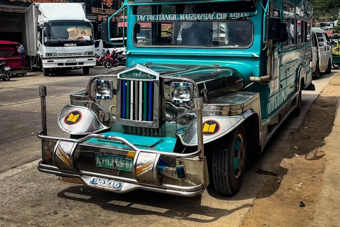 A brightly painted jeepney parked on a street in the Philippines