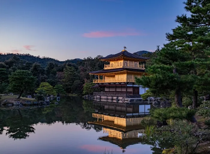 The golden Kinkaku-ji pavilion reflected in its lake at dusk, Kyoto