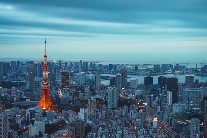 Tokyo Tower lit up above the Tokyo skyline at dusk
