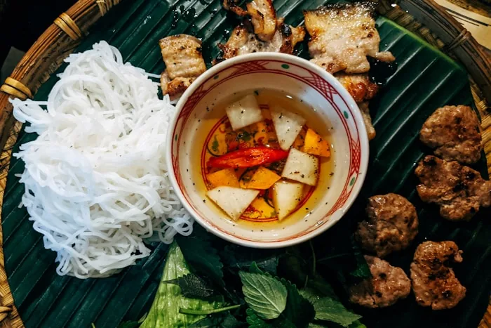 A bowl of Vietnamese pho with beef and herbs