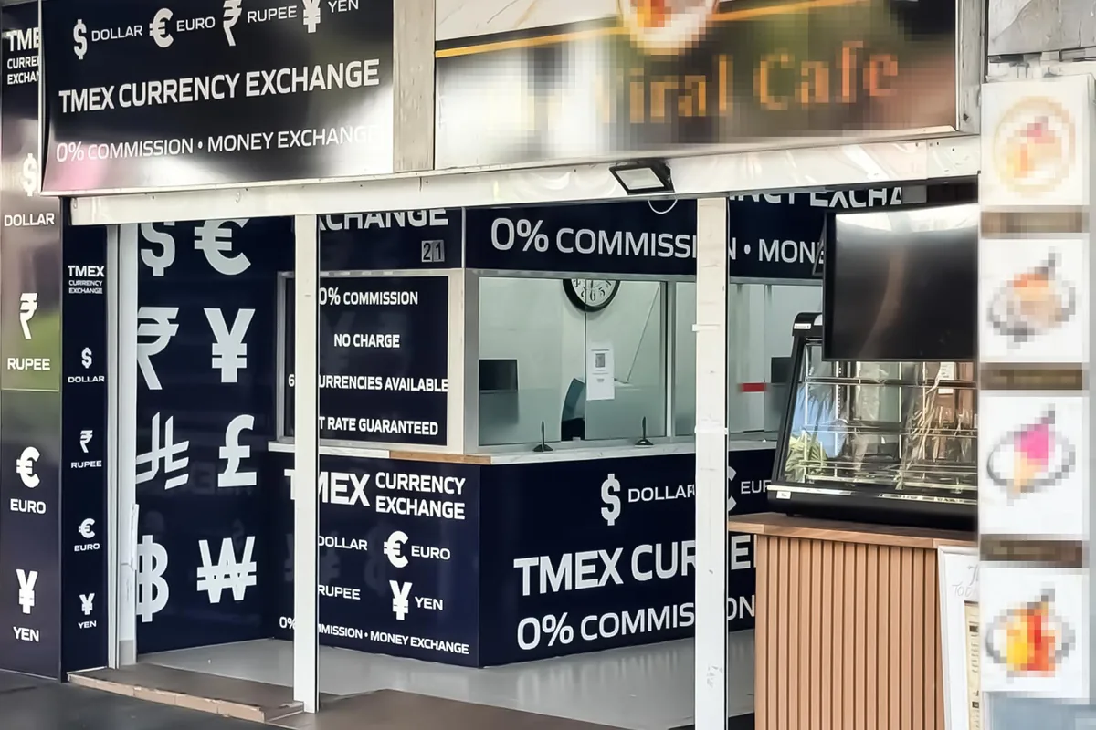 The TMEX Currency Exchange storefront on Auburn Road seen from the footpath, with the service window open to the street.